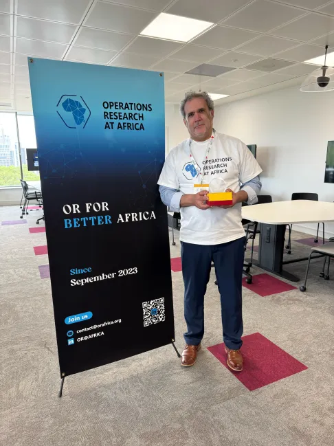 Presentation of a recognition trophy to Professor Issmail El Hallaoui for his invaluable support in the creation and development of the OR@Africa initiative